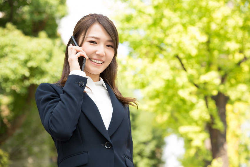 A business woman using business telephone system