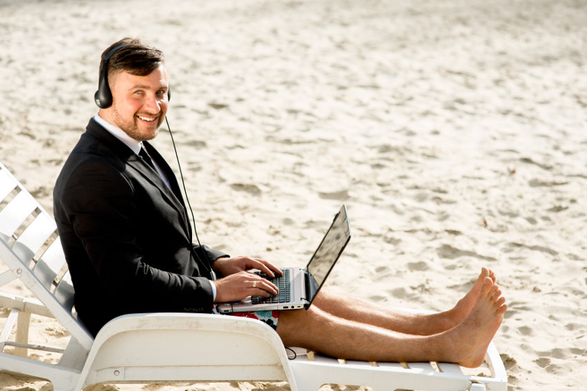 Businessman working at a beach