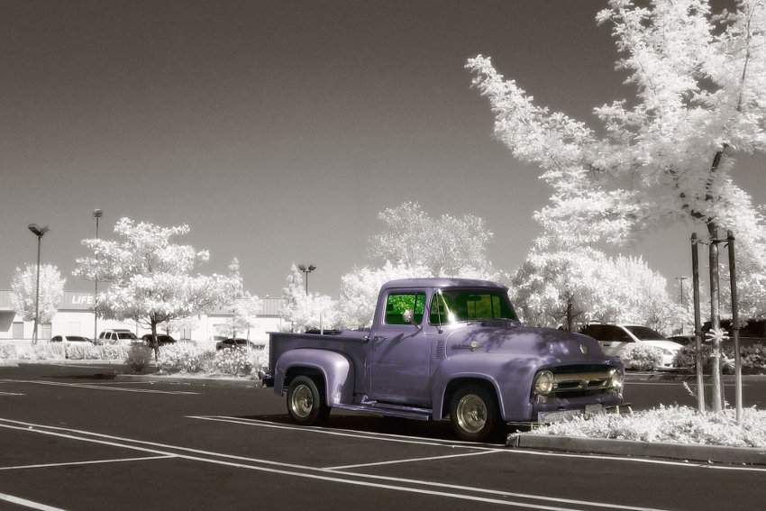 A purple truck on a parking lot