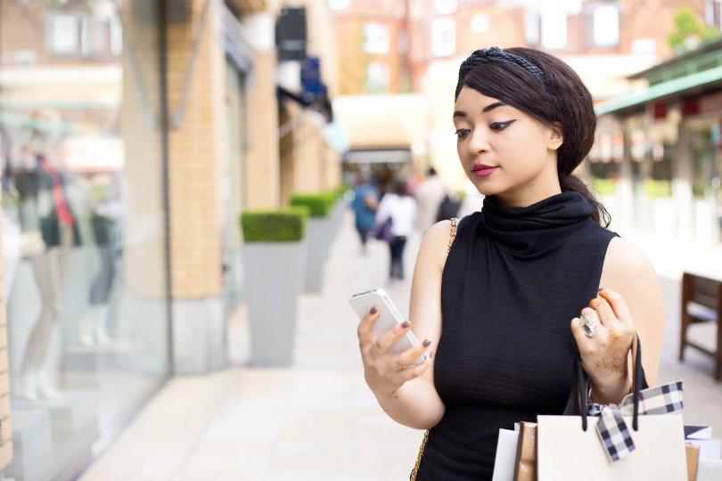 A shopper checking her social media updates