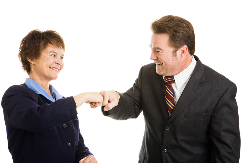 Business team members fist bumping