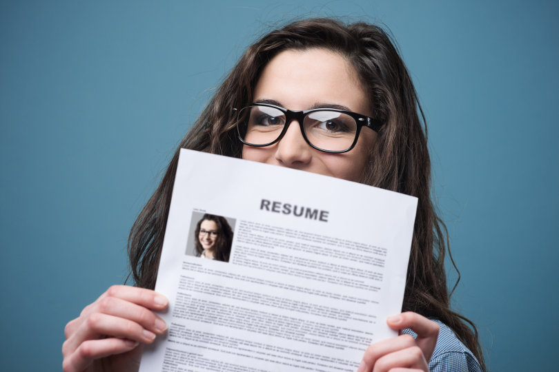 Young woman holding resume