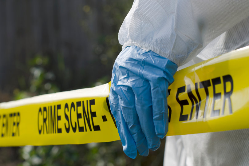 Forensic pathologist working at a crime scene