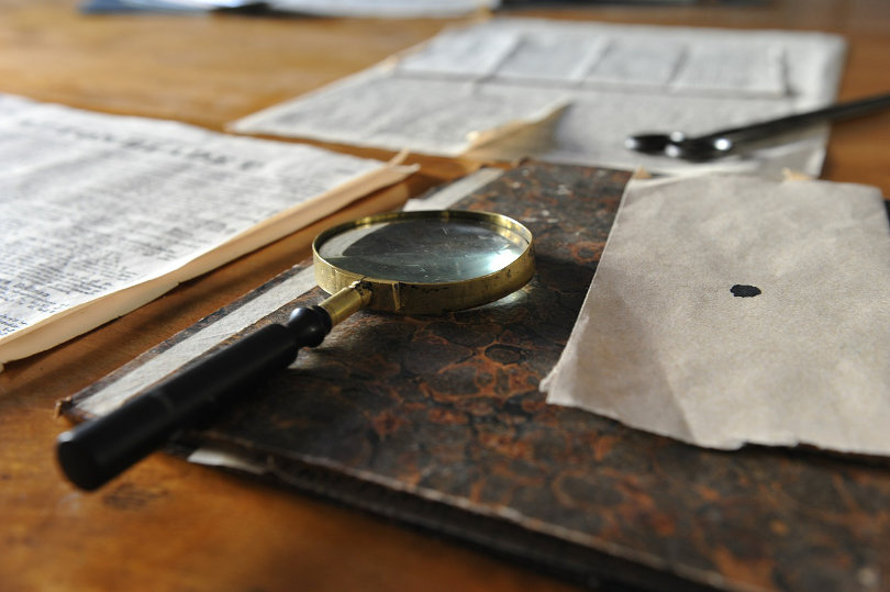 Old magnifying glass and old documents
