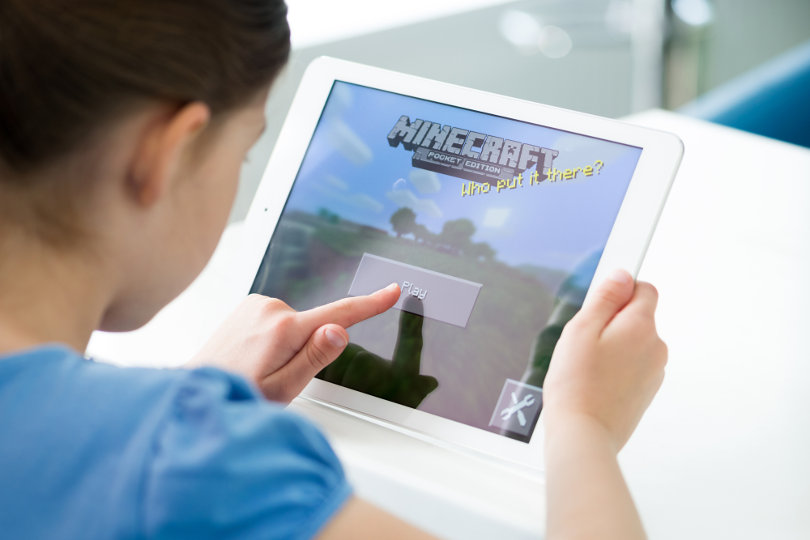 Girl playing Minecraft PE on iPad Air