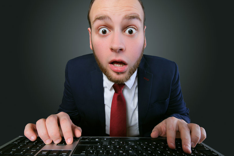 Shocked young businessman when shopping online
