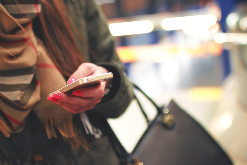 Woman holding an iPhone 4