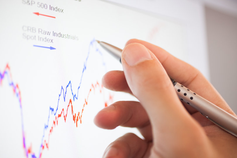 Stock trader analyzing graph