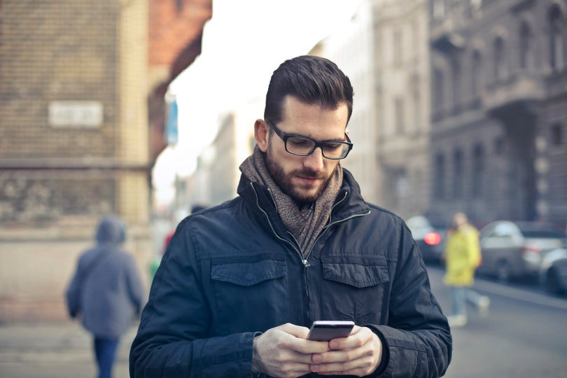 Man viewing mobile ad on his smartphone