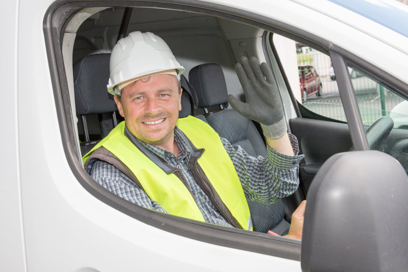Engineer driving a van in a construction site