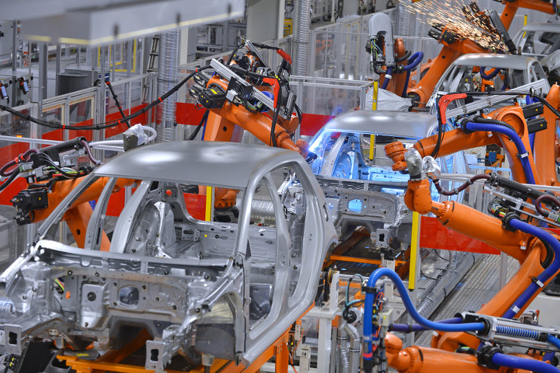 Robots welding in a factory