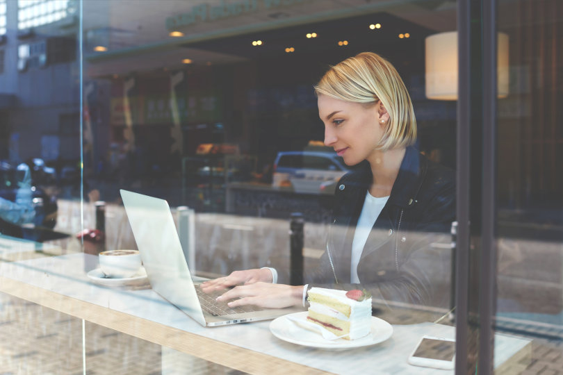 Blogger blogging in a cafe