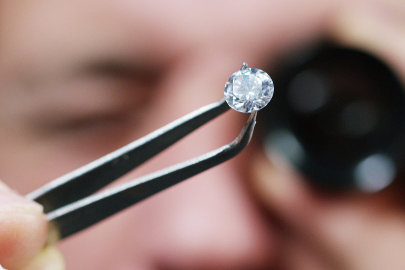 Diamond trader examining a diamond stone